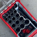 Set of sockets in a red tool case with close-up inset on a gray background