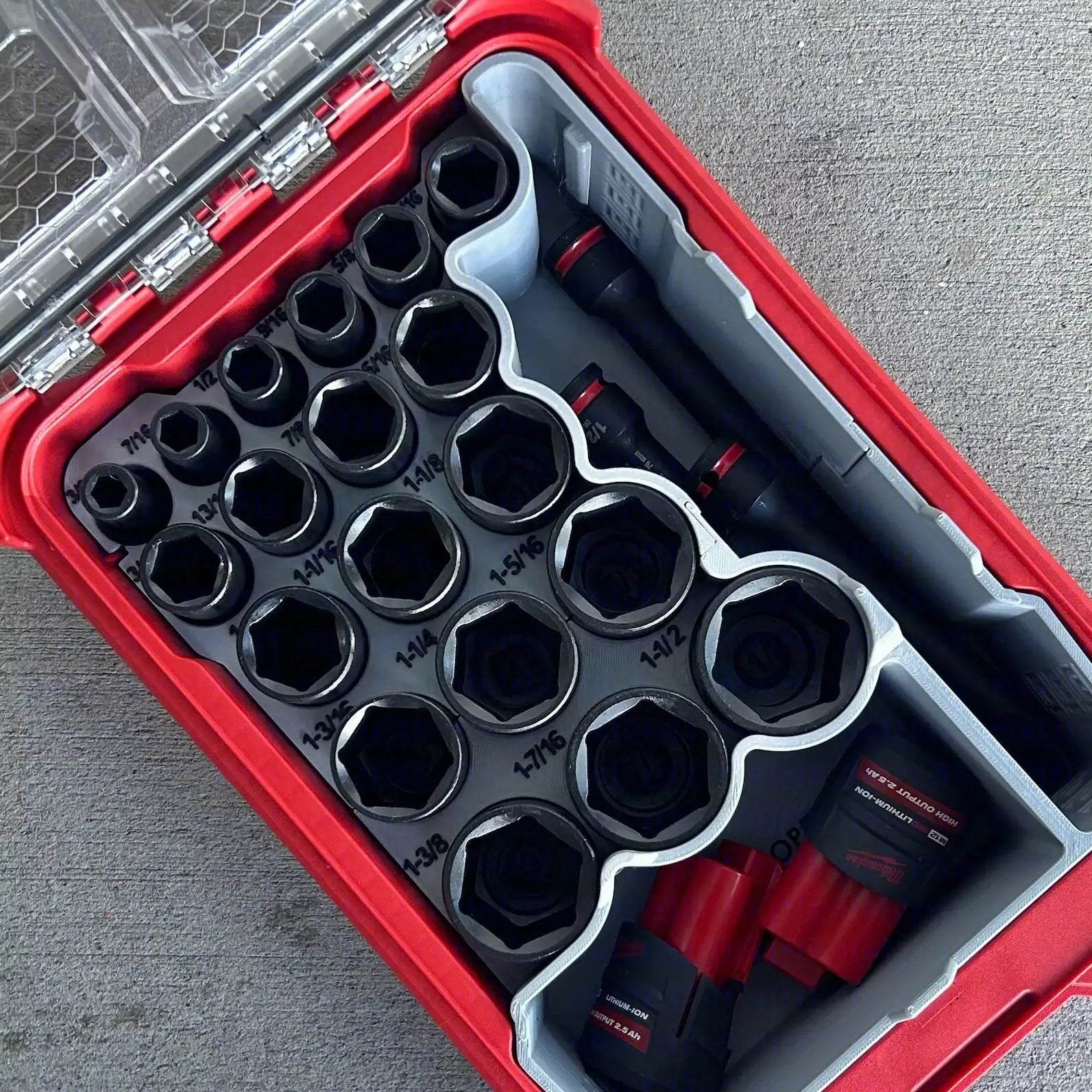 Set of sockets in a red tool case with close-up inset on a gray background